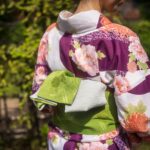 Back view of a woman's obi sash tied with elegance, highlighting the craft of Japanese kimono culture.