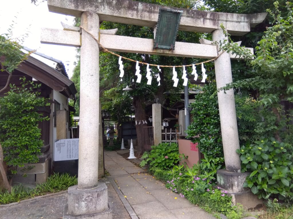 A quiet torii gate of a small shrine, symbolizing the spiritual stillness in everyday Japanese life.
