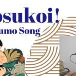 A singer-songwriter performing while playing the piano. The background features illustrated sumo wrestlers with a traditional Japanese design. Text on image reads “Dosukoi! Sumo Song.”